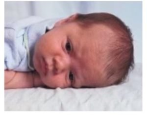Picture of a baby boy laying down.